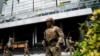 Members of Panama's National Aeronaval Service police stand outside the hotel where migrants from Asia and the Middle East are housed after being deported to Panama, in Panama City, Panama Feb. 18, 2025. 