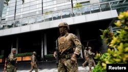 Members of Panama's National Aeronaval Service police stand outside the hotel where migrants from Asia and the Middle East are housed after being deported to Panama, in Panama City, Panama Feb. 18, 2025. 