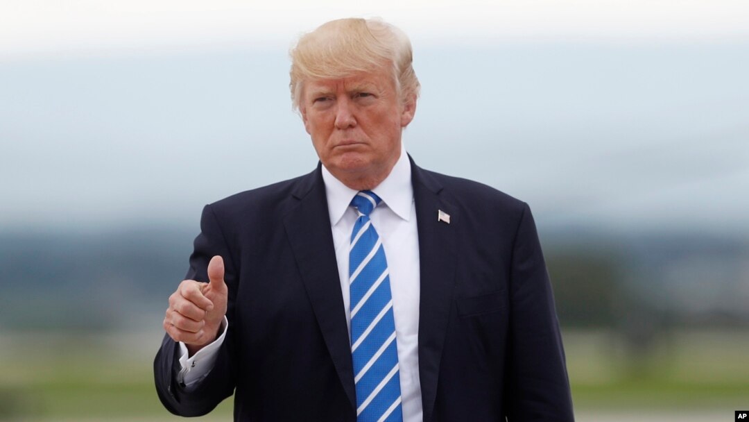 FILE - President Donald Trump gives a thumbs-up as walks to board on Air Force One at Hagerstown Regional Airport in Hagerstown, Md., Aug. 18, 2017.