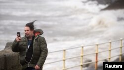 A man takes a selfie during storm Ophelia in the County Clare town of Lahinch, Ireland, Oct. 16, 2017. 