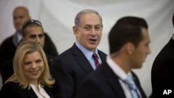 FILE - Israeli Prime Minister Benjamin Netanyahu and his wife Sara are seen arriving for the Likud party primary elections in Jerusalem in a Dec. 31, 2014, photo. 