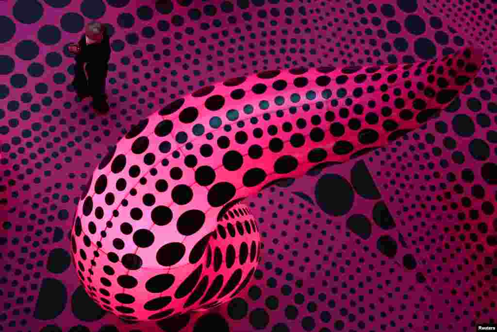 A man visits &quot;A Retrospective,&quot; an exhibition of the Japanese artist Yayoi Kusama at the museum Gropius Bau while COVID-19 restrictions continue to ease in Berlin, Germany.