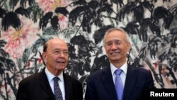 FILE - U.S. Commerce Secretary Wilbur Ross, left, chats with Chinese Vice Premier Liu He during a photograph session after their meeting at the Diaoyutai State Guesthouse in Beijing, China, June 3, 2018.