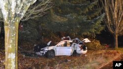 FILE: an Oregon man crashed a Tesla while going about 100 mph, starting a fire when some of the hundreds of batteries from the vehicle broke windows and landed in residences in Corvallis, Ore., on Tuesday, Nov. 17, 2020. This crash was NOT related to self-driving. 