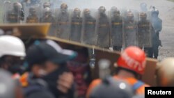 Venezuelan National Guard members take position while clashing with demonstrators rallying against Venezuela's President Nicolas Maduro in Caracas, Venezuela, June 6, 2017.