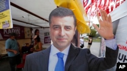 FILE - A cardboard cut-out of Selahattin Demirtas is pictured at an election kiosk in Istanbul, June 20, 2018. On Saturday, three senior figures from the Peoples' Equality and Democracy Party met Demirtas, the party's former co-chairperson, at Edirne prison near the Greek border.