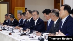 South Korean President Moon Jae-in speaks during a meeting with executives from South Korea's top 30 conglomerates at the Blue House in Seoul.