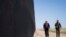 FILE - United State Border Patrol chief Rodney Scott gives President Donald Trump a tour of a section of the border wall in San Luis, Ariz. 