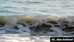 FILE - Wind blown waves from a tropical storm hit the beach at Carolina Beach, N. Carolina. (Photo: Diaa Bekheet)