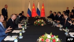 Russia's President Vladimir Putin (2nd L) holds talks with his China's counterpart Xi Jinping in Fortaleza, Brazil, on July 15, 2014.