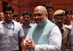 FILE - Indian Home Minister Amit Shah greets reporters upon his arrival at the home ministry in New Delhi, June 1, 2019.
