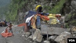 Penduduk berusaha menyelamatkan truk bermuatan semen yang rusak akibat tertimpa tanah longsor di Gangtok, India. (20/9).