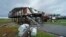 Storm clouds from approaching Tropical Storm Nicholas are seen behind homes destroyed by Hurricane Ida, in Pointe-aux-Chenes, La., Tuesday, Sept. 14, 2021. (AP Photo/Gerald Herbert)