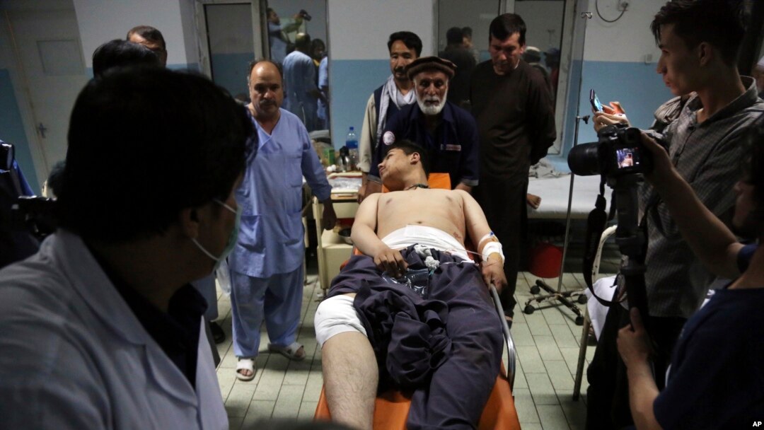 An injured man is brought into a hospital following deadly blasts at a wrestling club in Kabul, Afghanistan, Sept. 5, 2018.