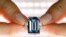 A Christie's employee poses with the 14.62 carats Oppenheimer Blue diamond during a preview in Geneva, Switzerland, May 12, 2016.  