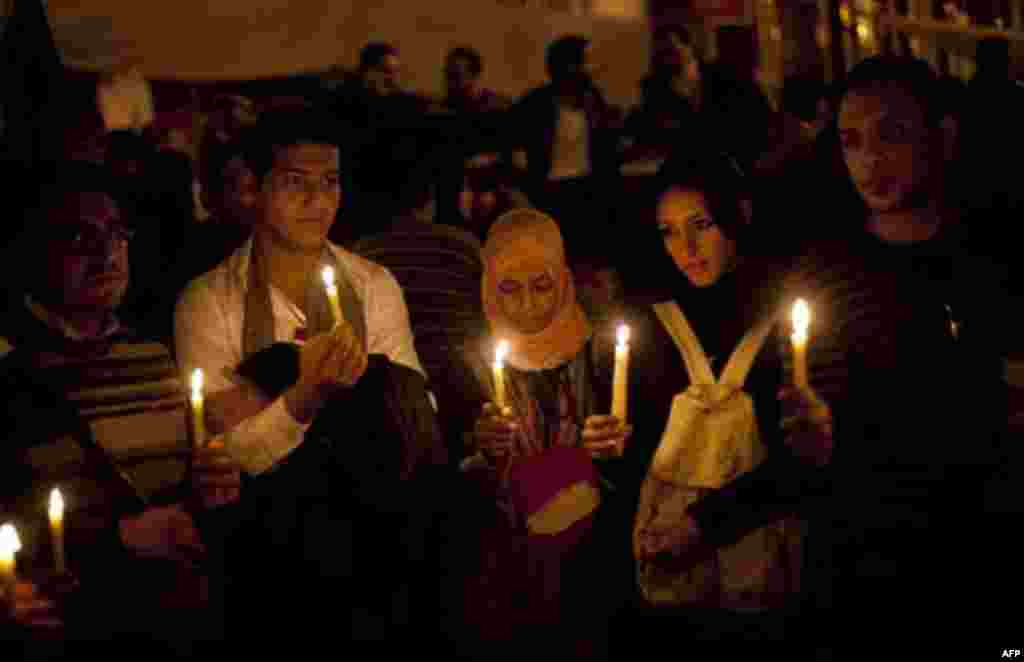 Anti-government protestors hold candles as they take part in a demonstration at Tahrir square in Cairo, Egypt, Wednesday, Feb. 9, 2011. Protesters appear to have settled in for a long standoff, turning Tahrir Square into a makeshift village with tens of t