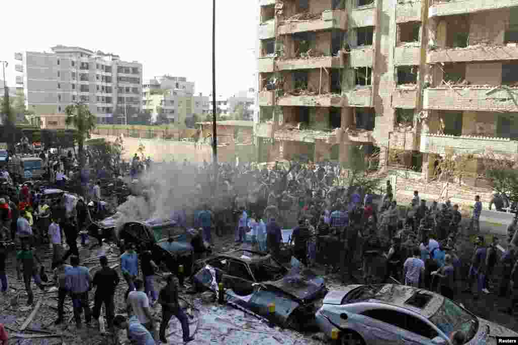 Soldiers, policemen and medical personnel gather at the site of explosions near the Iranian embassy in Beirut, Nov. 19, 2013.