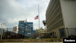 The U.S. flag is lowered to half mast in front of a damaged fence of the U.S. embassy after Hurricane Irma caused flooding and a blackout, in Havana, Cuba Sept. 11, 2017. 