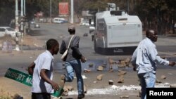 FILE - Opposition party supporters clash with police in Harare, Zimbabwe, Aug. 26, 2016.