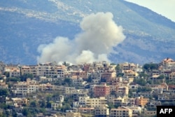 Smoke billows from the tract  of an Israeli airstrike successful  the confederate  Lebanese colony   of Khiam adjacent   the borderline  connected  Sept. 19, 2024.