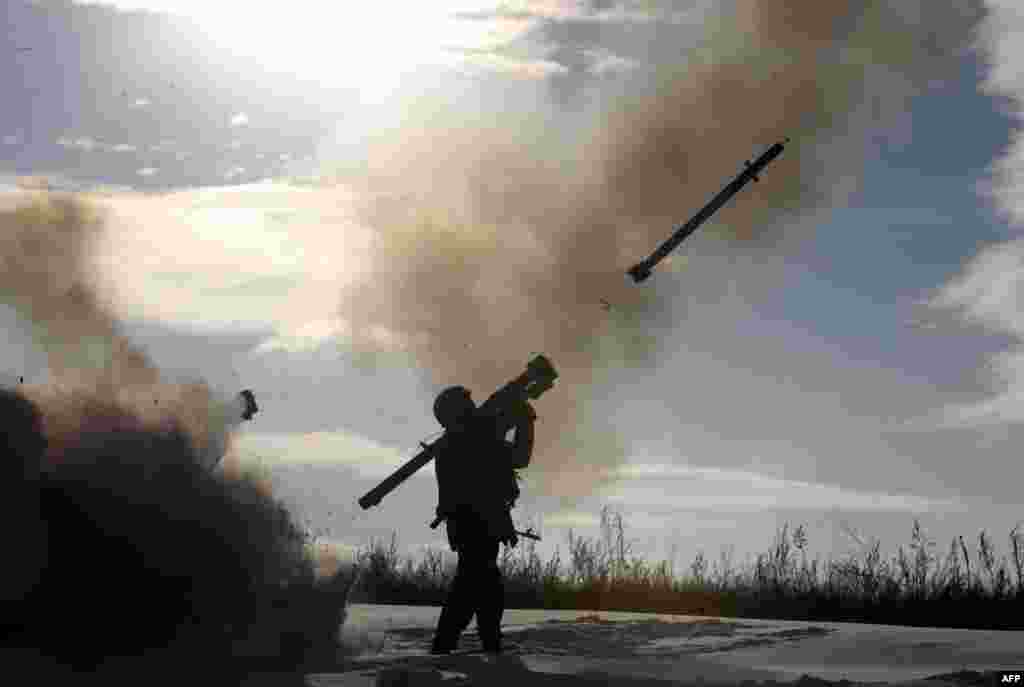 A Ukrainian soldier fires a missile with a man-portable air-defense system during exercises near the city of Shchastya, north of Lugansk.
