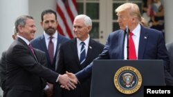 Brian Cornell, the CEO of Target Corporation, shakes hands with U.S. President Donald Trump after the president declared the coronavirus pandemic a national emergency March 13, 2020. (REUTERS/Jonathan Ernst)