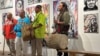 FILE - Native American climate activist and artist Jacob Johns, right, drums with members of the Santa Clara Pueblo tribe of New Mexico in Santa Fe, July 11, 2024. Johns was shot at a protest in the state in 2023.