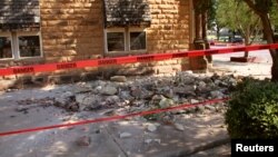 Stonework litters the sidewalk outside an empty jewelry store at the corner of Sixth and Harrison in Pawnee, Oklahoma, after a 5.6 magnitude earthquake struck near the north-central Oklahoma town, Sept. 3, 2016.