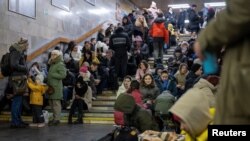 People take shelter inside the metro station during Russian missile attacks in Kyiv