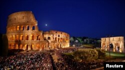 FILE—People gather outside of Colosseum ahead of Via Crucis (Way of the Cross) procession during Good Friday celebrations, Rome Italy.