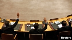 FILE - Members of the United Nations Security Council vote to tighten sanctions on North Korea at the United Nations Headquarters in New York, March 7, 2013. 