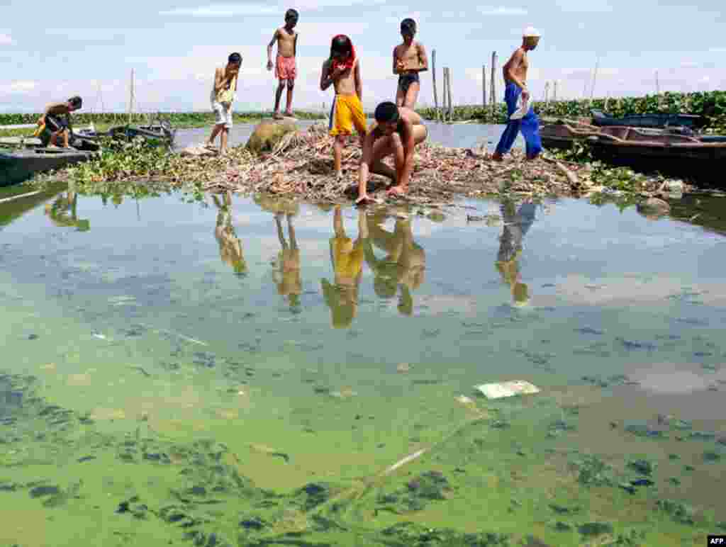 March 22: Children play near murky waters at Laguna de Bay in Taguig City, Manila. The U.N. World Water Day is held on March 22 every year to increase people's awareness of water's importance in environment, agriculture, health and trade. (Reuters)