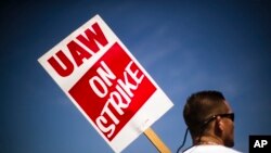 A worker pickets outside a General Motors facility in Langhorne, Pennsylvania, Sept. 23, 2019.