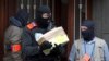 Belgium police leave after an investigation in a house in the Anderlecht neighborhood in Brussels, Belgium, March 23, 2016.