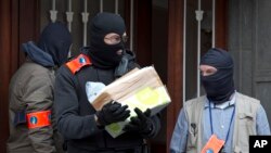 Belgium police leave after an investigation in a house in the Anderlecht neighborhood in Brussels, Belgium, March 23, 2016.