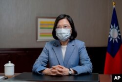 In this photo released by the Taiwan Presidential Office, Taiwan's President Tsai Ing-wen speaks at the presidential office in Taipei, Taiwan, Sunday, June 20, 2021.