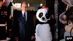 President Joe Biden, second from left, stands with first lady Jill Biden — in a panda costume — at a Halloween event at the White House in Washington, Oct. 30, 2024.