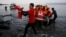 A Red Cross volunteer carries a Syrian refugee baby off an overcrowded raft at a beach on the Greek island of Lesbos Nov. 16, 2015. 
