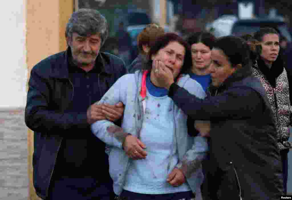 A woman reacts in the city of Durres after an earthquake shook Albania, Nov. 26, 2019. 