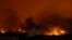 Structures burn in the Waldo Canyon wildfire, creating a glow above the western side of Colorado Springs, Colo., June 26, 2012.