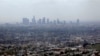 FILE - EPA officials set to announce new standards on Friday; above, smog covers downtown Los Angeles, Calif., April 2009.