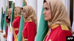 FILE - Mujahedin-e Khalq honor guard members stand watch in Manza, Albania, July 12, 2019. An Iranian paramilitary network was allegedly targeting Mujahedin-e Khalq group members in Albania, police said Wednesday.