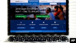 FILE - The Healthcare.gov website is seen on a computer screen in Washington, Oct. 18, 2017. The government says about 8.8 million people have signed up for coverage next year under the Affordable Care Act.