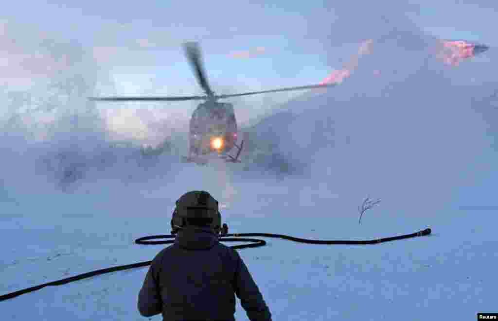 A helicopter taking part in the operation to recover the bodies of skiers hit by an avalanche on Blabaerfjellet mountain on January 2, 2019, in northern Norway.