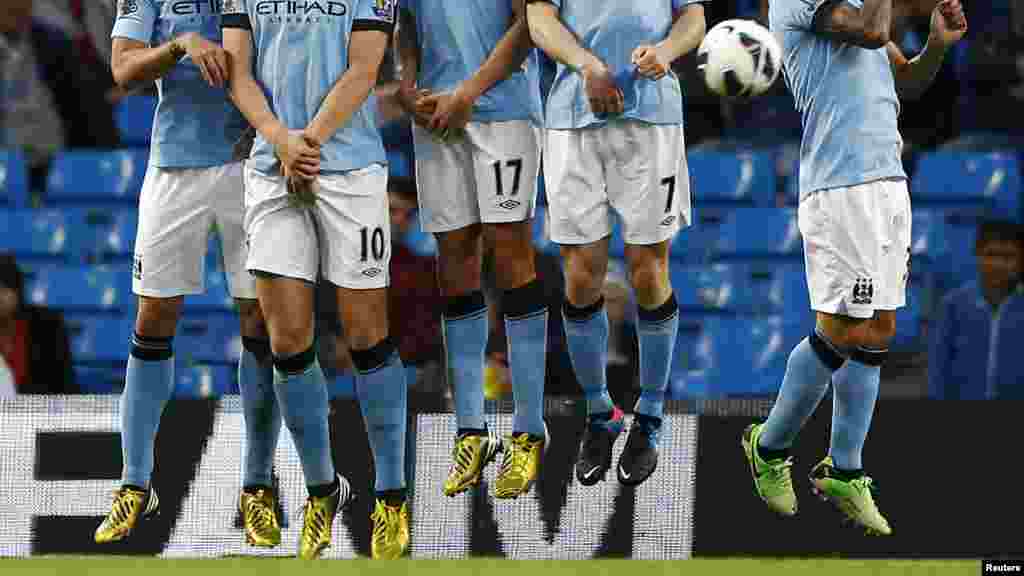Manchester City players defend a West Bromwich Albion free kick during their English Premier League soccer match in Manchester, May 7, 2013.