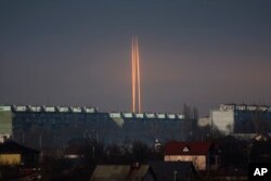 Three Russian rockets launched against Ukraine from Russia's Belgorod region are seen at dawn in Kharkiv, Ukraine, Thursday evening, March 9, 2023. (AP/Vadim Belikov)