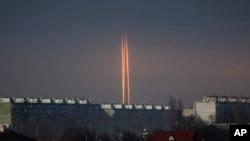 Three Russian rockets launched against Ukraine from Russia's Belgorod region are seen at dawn in Kharkiv, Ukraine, March 9, 2023.