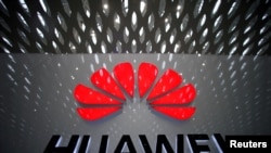 FILE - A Huawei company logo at Shenzhen International Airport in Shenzhen, Guangdong province, China.
