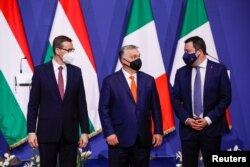 FILE - Hungary's Prime Minister Viktor Orban, Poland's Prime Minister Mateusz Morawiecki and Italy's League party leader Matteo Salvini pose for a picture after a news conference following their meeting in Budapest, Hungary, Apr. 1, 2021.