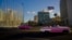 FILE - Tourists ride in classic American convertible cars past the United States embassy, right, in Havana, Cuba, Jan. 12, 2017.